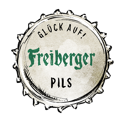 Kronkorken mit dem Schriftzug Freiberger Pils und dem Zusatz Glück Auf im oberen Bereich.