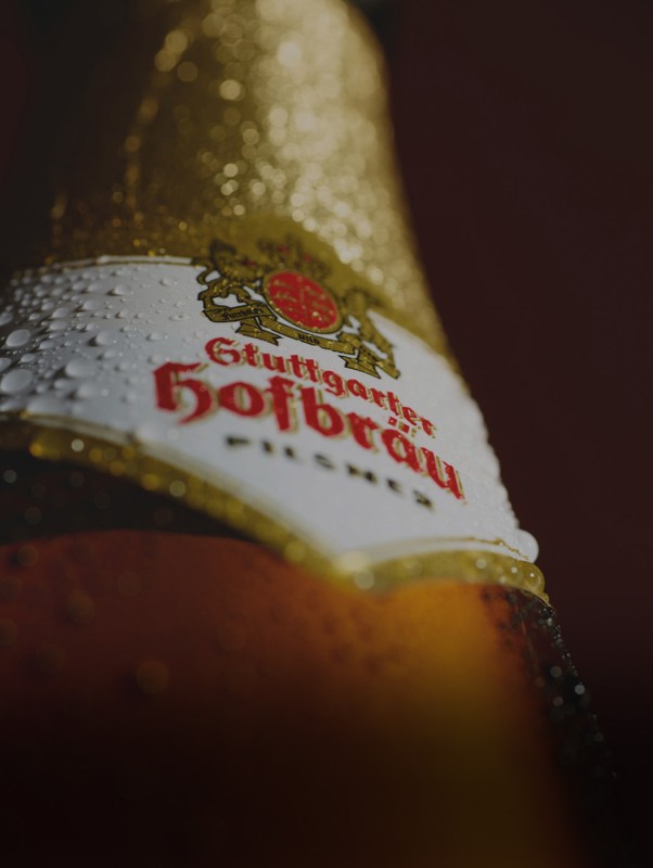 Eine Flasche Getränk mit Wassertropfen ist aus nächster Nähe und schräg fotografiert. 