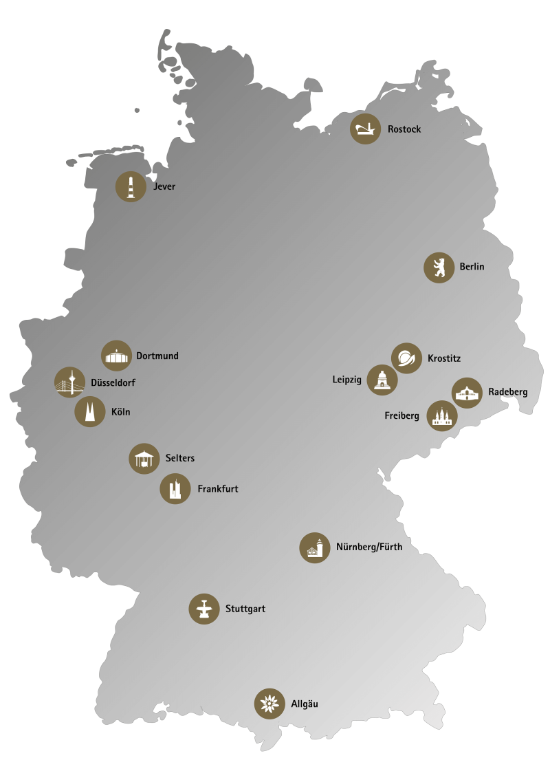 Graue Karte von Deutschland mit markierten Städten und Symbolen, die regionale Besonderheiten darstellen.