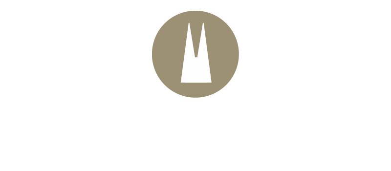 Weißes Doppelturm-Motiv mit schmaler Lücke in der Mitte auf rundem goldenem Hintergrund. Form ist spitz und symmetrisch.